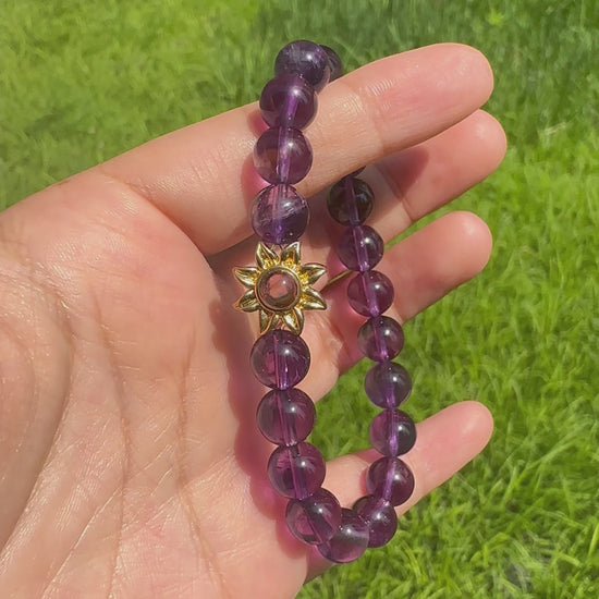 Hidden pet photo projection shown through amethyst bracelet charm