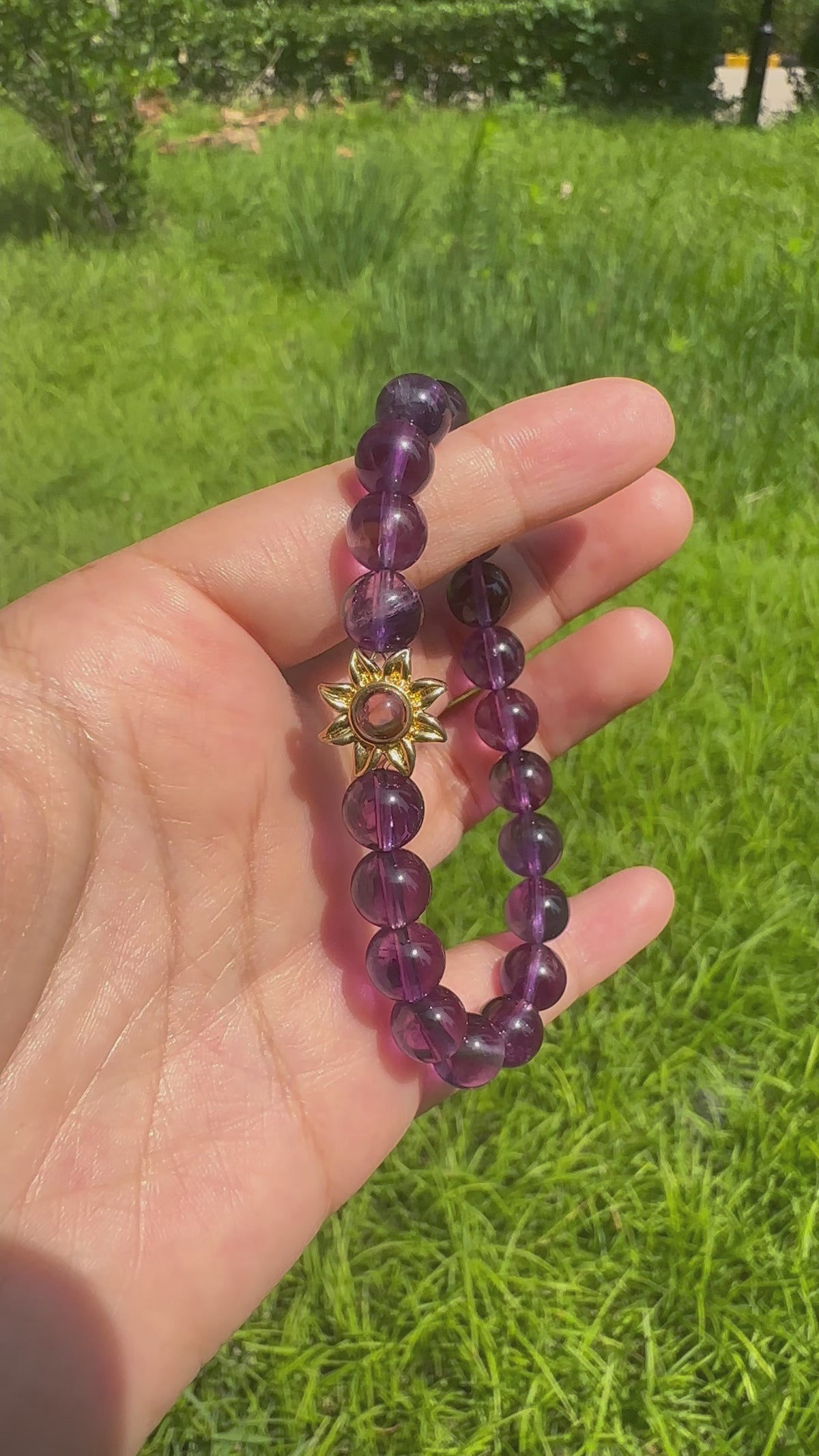 Hidden pet photo projection shown through amethyst bracelet charm